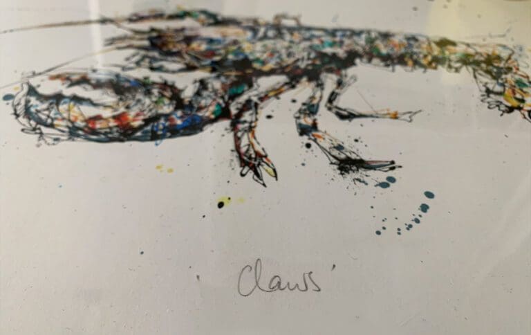 A close up showing the handwritten titled of 'Claws' on a print by Kathryn Callaghan which features a European lobster.