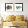 Two prints by Kathryn Callaghan shown in black frames in situ in a sunny bedroom above a golden yellow bedspread. The prints are titled Temple Bar Dublin and Ha'penny Bridge Dublin, and both depict the Dublin landmarks they're named for, and are 45cm square each.