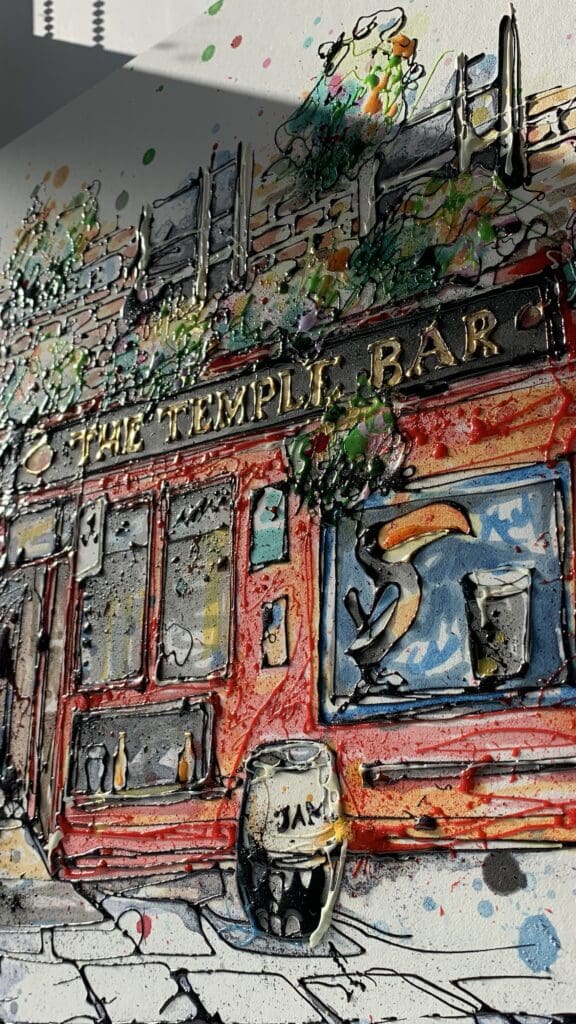 A close up of an original poured painting by Kathryn Callaghan of The Temple Bar in Dublin. The photograph is taken from a low angle and shows the texture of the ink gels in the sunlight.