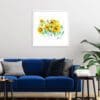 A 45cm square print by Kathryn Callaghan shown hung in situ in a slim white frame above a cobalt blue sofa and a large palm plant. The print is named 'Happy Days' and features a spray of seven vivid daffodils.