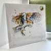 A print of Hover by Kathryn Callaghan, which features a barn owl in flight. The 30cm print is presented flat in a clear cello bag with a golden KC sticker in the top right.