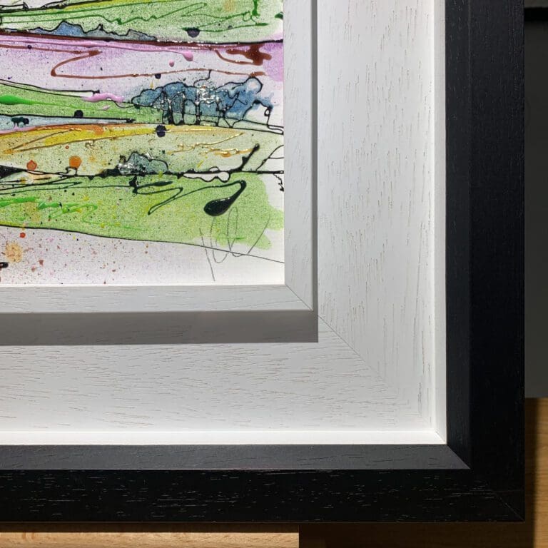 The bottom right corner of Across the Drumlins, an original painting by Kathryn Callaghan, which shows the two part white and black wooden frame and the artist's signature on the painting.