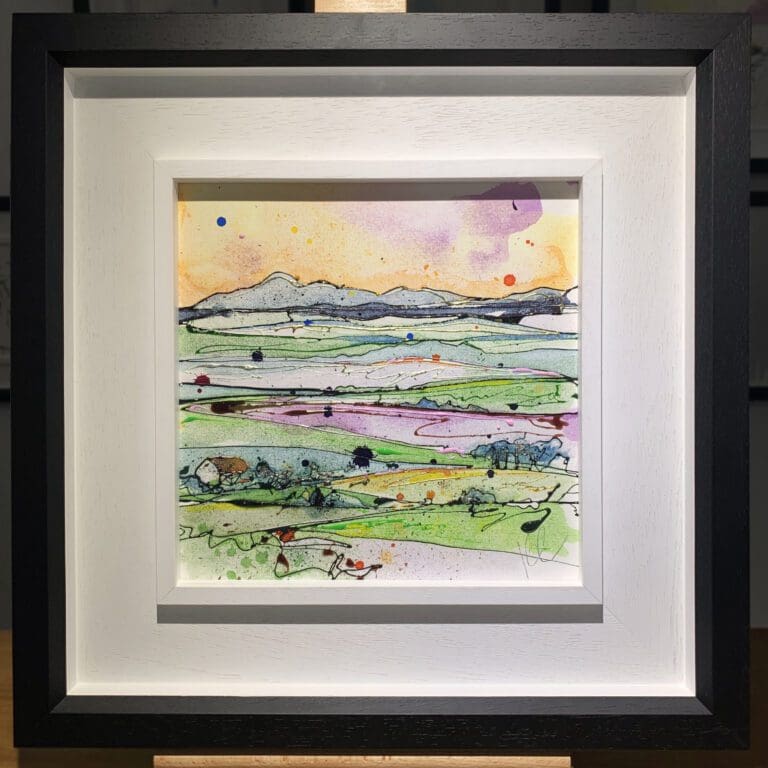 An original painting named Across the Drumlins by Kathryn Callaghan, featuring a rolling landscape inspired by County Down, Northern Ireland. The painting is framed in a two part white and black frame.