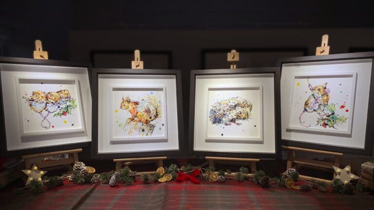 Four original paintings by Kathryn Callaghan from her Winter 2023 range, featuring Three Amigos (three mice clinging to a holly branch), Happy Go Lucky (an energetic red squirrel), Tiny Steps (a bight eyed hedgehog), and Just Hanging Around (a mouse climbing up a holly branch).