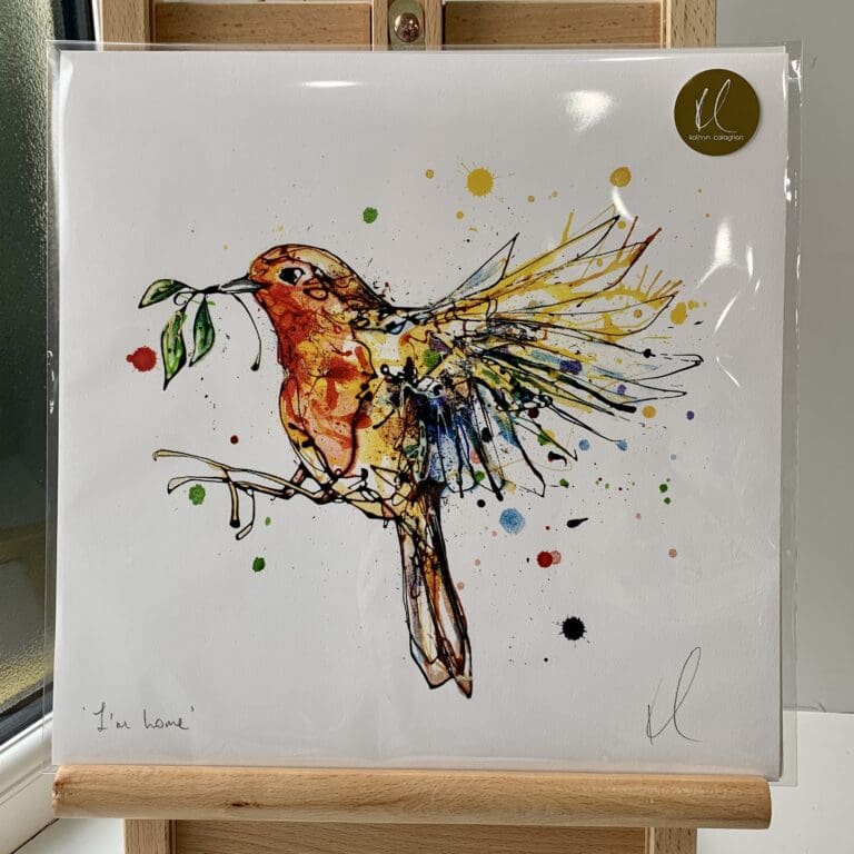 A print of I'm Home by Kathryn Callaghan, which features a robin in flight with a sprig of mistletoe. The 30cm print is presented flat in a clear cello bag with a golden KC sticker in the top right.