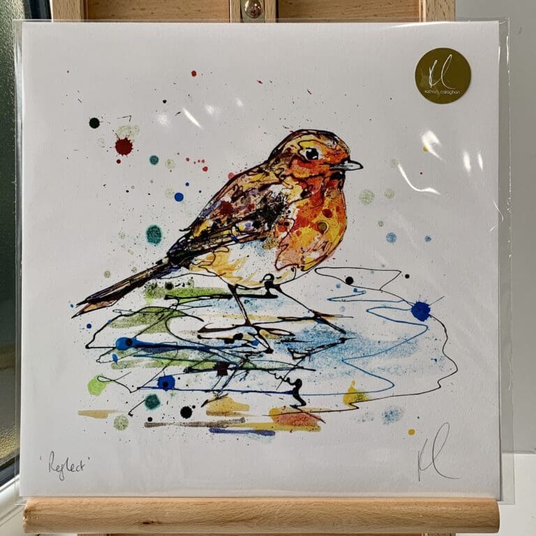 A print of Reflect by Kathryn Callaghan, which features a robin standing in a pool of water. The 30cm print is presented flat in a clear cello bag with a golden KC sticker in the top right.