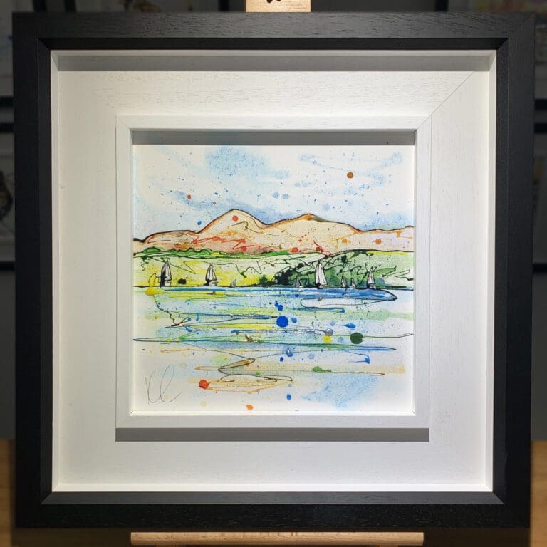 An original painting named Set Sail, Strangford Lough by Kathryn Callaghan, featuring a view from the surface of Strangford Lough to the Mournes in Northern Ireland, with sailboats on the water. The painting is framed in a two part white and black frame.