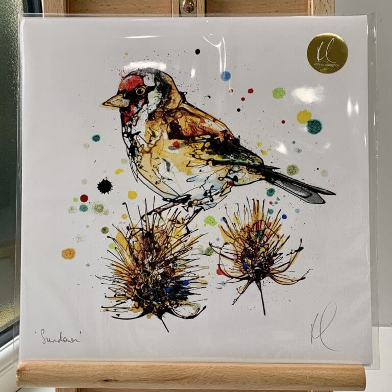 A print of Reflect by Kathryn Callaghan, which features a goldfinch perched on a thistle. The 30cm print is presented flat in a clear cello bag with a golden KC sticker in the top right.