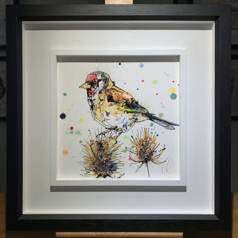 An original painting named Sundown by Kathryn Callaghan, featuring a goldfinch perched on a thistle. The painting is framed in a two part white and black frame.