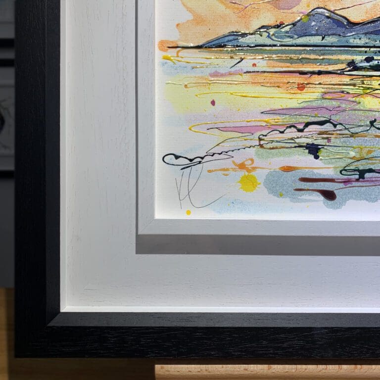 The bottom left corner of The Mournes at Sunset, an original painting by Kathryn Callaghan, which shows the two part white and black wooden frame and the artist's signature on the painting.