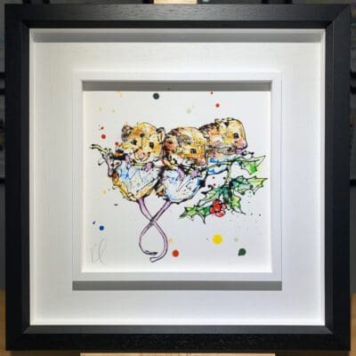 An original painting named Three Amigos by Kathryn Callaghan, featuring three mice clambering on a sprig of holly. The painting is framed in a two part white and black frame.