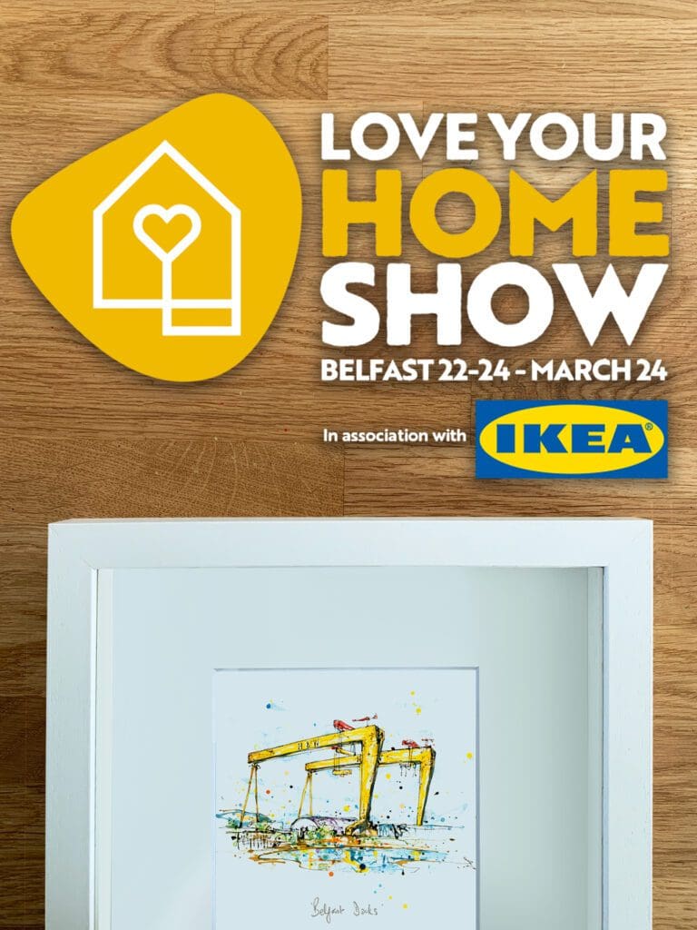 An image advertising that Kathryn Callaghan Fine Art will be at Love Your Home Belfast 2024. A framed print of the Belfast Harland & Wolff cranes, named 'Belfast Docks', by Kathryn Callaghan. Digital text above reads "Love Your Home Show, Belfast, 22-24th March 2024, in association with Ikea".