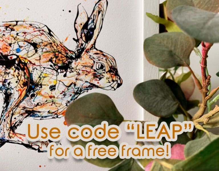 An advertisement for a special offer from Kathryn Callaghan Fine Art for the 2024 Leap Year, offering a free frame for any 30x30cm print. A print of a running hare, named Like The Wind, sits in a white frame behind eucalyptus leaves, with a digital brushstroke running behind the print and digital text reading "Use code "LEAP" for a free frame!"