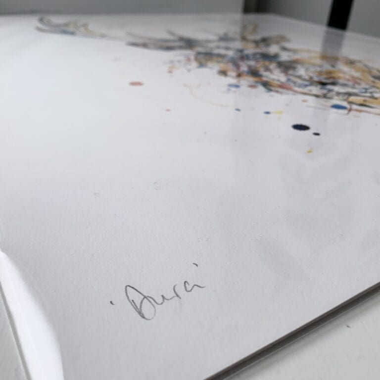 An angled close up photograph of the hand-written title present on Aura, a stag print by Kathryn Callaghan.