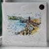 A 30cm print of Bangor Pier by Kathryn Callaghan, shown packaged with a backing board in a clear cello bag with a gold KC sticker.