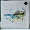 A 30cm print of Benone Strand by Kathryn Callaghan, shown packaged with a backing board in a clear cello bag with a gold KC sticker.