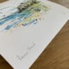 Photograph of Benone Strand by Kathryn Callaghan, which shows the print's title handwritten in the bottom left corner and the artist's signature in the bottom right, with space between to add a custom personalisation.