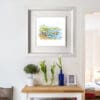 A 30x30cm print of Causeway Rocks by Kathryn Callaghan shown in a deluxe white frame in situ.