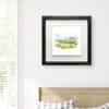 A 30x30cm print of Glens of Antrim by Kathryn Callaghan, shown in a Deluxe Black frame in situ.